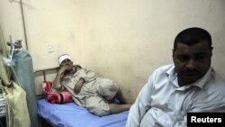 A man wounded in a bomb attack lies at a hospital in Kerbala, 110 km (70 miles) south of Baghdad, June 13, 2012.