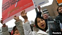People from South and North Korea, the U.S. and Poland protest against abuses of human rights in North Korea outside the North Korean embassy in Warsaw.
