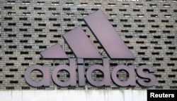 The logo of Adidas is seen on an outlet store in Metzingen, Germany, June 16, 2017.