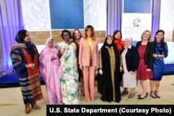 The recipients of the 2018 International Women of Courage awards gather for a group photo with first lady Melania Trump, March 23, 2018, at the State Department in Washington.