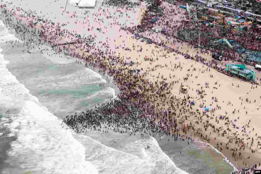 This aerial view shows thousands of revelers and holidaymakers gathering at the North Pier Beach during New Year Celebrations in Durban, South Africa.