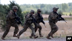 Members of the U.S. Army's 173rd Airborne Brigade practice during the combined Lithuanian-U.S. training exercise at the Gaiziunai Training Area, west of Vilnius, Lithuania, July 7, 2015.