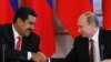 Russian President Vladimir Putin (R) shakes hands with his Venezuelan counterpart Nicolas Maduro during a signing ceremony at the Kremlin in Moscow, July 2, 2013.