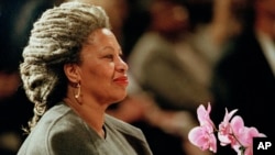 FILE - In this April 5, 1994, file photo, Toni Morrison holds an orchid at the Cathedral of St. John the Divine in New York. (AP Photo/Kathy Willens, File)