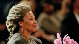 FILE - In this April 5, 1994, file photo, Toni Morrison as she holds an orchid at the Cathedral of St. John the Divine in New York. Publisher Alfred A. Knopf says Morrison died Aug. 5, 2019, at Montefiore Medical Center in New York. She was 88. (AP Photo/