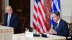 Secretary of State Antony Blinken speaks as Greece's Foreign Minister Nikos Dendias looks on during an event at the State Department in Washington, Oct. 14, 2021.