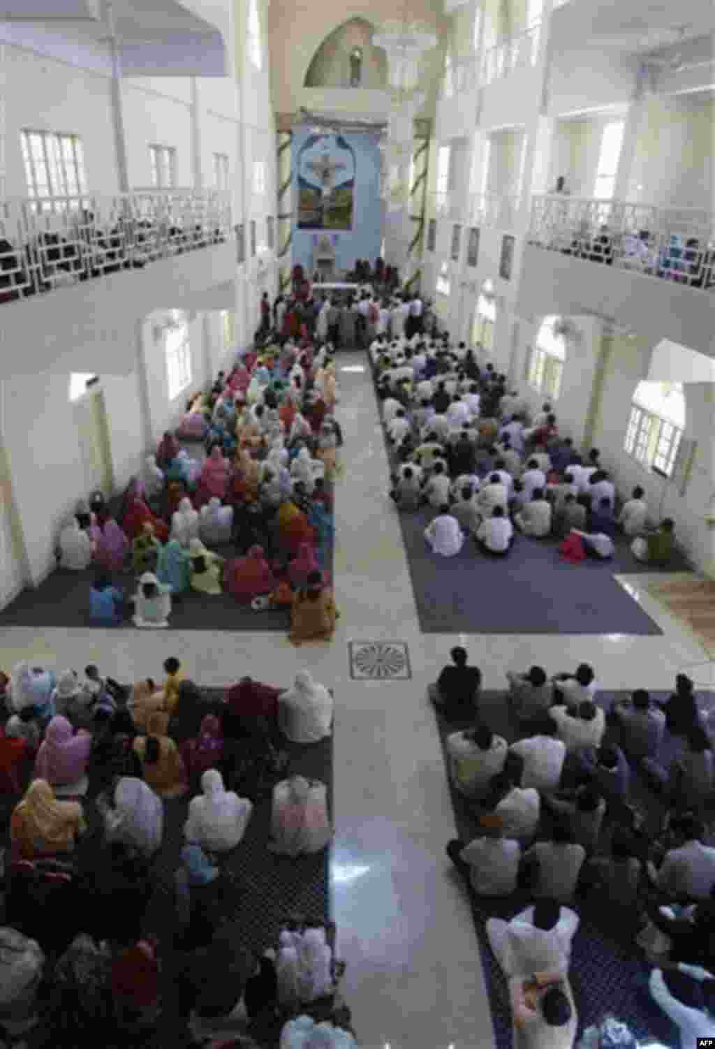 In this Nov. 14, 2011, photo, people from the Pakistani Christian community attend a Sunday service at St. Peter's church in Karachi, Pakistan. Pakistan's tiny and underfire Christian community thought big when constructing its latest church _ a domed, th