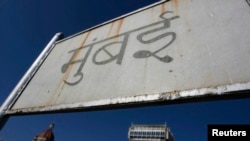 FILE - A Hindi-language signboard which reads "Mumbai" is seen near the Taj Mahal hotel in Mumbai.