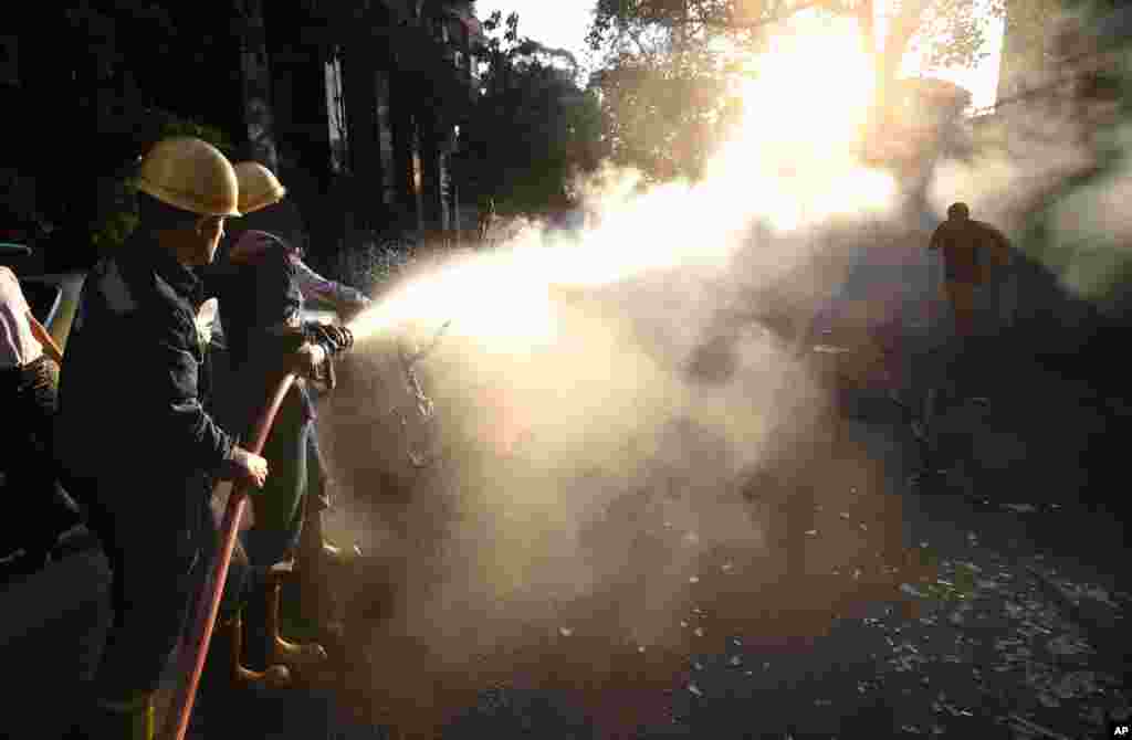 Firefighters extinguish a scooter that was set on fire during clashes between opponents and supporters of ousted President Morsi in Cairo, July 22, 2013.