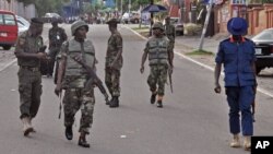 Nigerian soldiers patrol the area, near the scene of an explosion in Abuja, Nigeria, Wednesday, June 25, 2014.