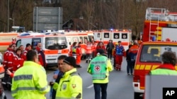 Rescue personnel wait in Bad Aibling, Germany after two regional trains crashed, killing at least two people, Feb. 9, 2016.