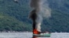 An unmanned Vietnamese fishing boat is blown up and sunk by the Indonesian navy, off the Natuna sea in Anambas, Kepulauan Riau province, Indonesia, Dec. 5, 2014.