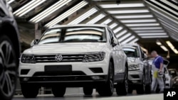 FILE - Volkswagen cars are pictured as they undergo a final quality control check at the Volkswagen plant in Wolfsburg, Germany, March 8, 2018.