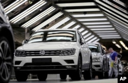 FILE - Volkswagen cars are pictured as they undergo a final quality control at the Volkswagen plant in Wolfsburg, Germany, March 8, 2018.