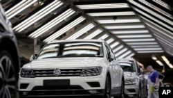 FILE - Volkswagen cars are pictured as they undergo a final quality control at the Volkswagen plant in Wolfsburg, Germany, March 8, 2018.