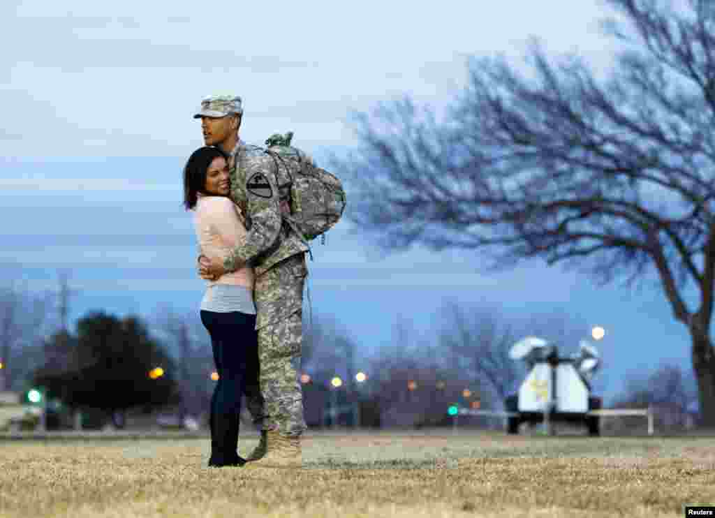 Private Devin Alderman from the 3rd Brigade, 1st Cavalry Division hugs his girlfriend, Gislaine Powers, during a homecoming ceremony at Fort Hood, Texas December 21, 2011. (Reuters)