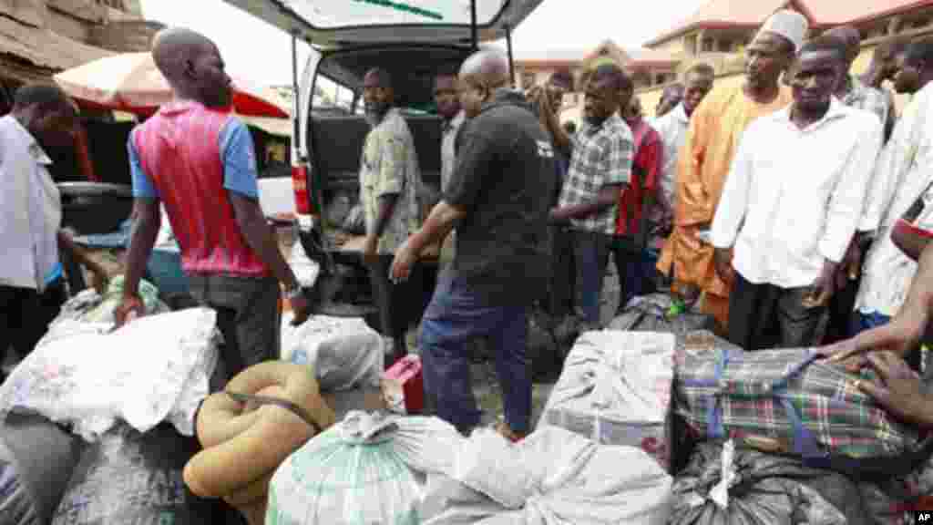 Citizens of Niger wait to board a commercial bus at Katangua market in Lagos, Nigeria.