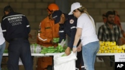 Venezuelan volunteers, Colombian firefighters and rescue workers prepare USAID humanitarian aid for storage at a warehouse next to the Tienditas International Bridge, near Cucuta, Colombia, on the border with Venezuela, Feb. 8, 2019.