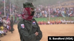 A Karen National Police Force officer watches the Karen Revolution day ceremonies Jan. 31, 2019, in Karen state, Myanmar, near the Thai-Myanmar border.