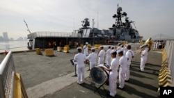 A Philippine Navy Band plays as the Russian Navy vessel Admiral Tributs, a large anti-submarine ship, docks at Manila's pier, Philippines, Jan. 3, 2017. Two Russian Navy Vessels are in the country for a goodwill visit until Jan. 7.