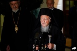 FILE - Ecumenical Patriarch Bartholomew I, the spiritual leader of the world's Orthodox Christians, talks to reporters outside the West Wing of the White House in Washington, Oct. 25, 2021, following his meeting with President Joe Biden.