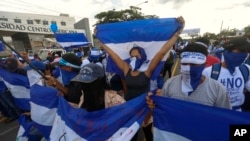 Manifestantes antigubernamentales marchan frente a la Universidad Centroamericana (UCA) en Managua, Nicaragua, el miércoles 26 de septiembre de 2018.