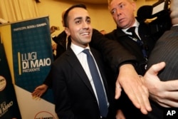 5-Stars Movement's leader Luigi Di Maio smiles as he arrives for a press conference on the preliminary election results, in Rome, March 5, 2018.