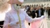 People wear protective face masks in St. Mark's Square after the last days of Venice's Carnival were cancelled due to the coronavirus, in Venice, Italy, 24, 2020.