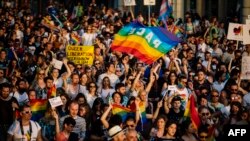 FILE - People hold a rainbow flag reading "Peace" as they take part in the annual Gay Pride Parade in downtown Sofia, Bulgaria, June 8, 2019. 