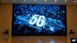 A 5G logo is displayed on a screen outside the showroom at Huawei campus in Shenzhen city, China's Guangdong province. 