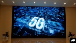 A 5G logo is displayed on a screen outside the showroom at Huawei campus in Shenzhen city, China's Guangdong province. 