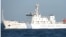 A combination photo shows two Chinese surveillance ships which sailed between a Philippines warship and eight Chinese fishing boats to prevent the arrest of any fishermen in the Scarborough Shoal, April 10, 2012.