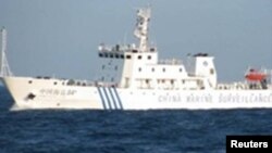 Chinese surveillance ship sails between a Philippine warship and eight Chinese fishing boats to prevent the arrest of any fishermen in the Scarborough Shoal, April 10, 2012.