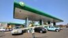 FILE - A man carries goods past a gas station in Lilongwe, Malawi, July 14, 2011. 