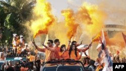 Incumbent Madagascar President Andry Rajoelina, candidate in the 2023 presidential election, his wife Mialy Rajoelina and their three children, ride in a pickup truck to greet supporters during his re-election campaign, in Toamasina, November 11, 2023