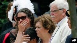 Family and friends watch as the casket of Virginia Beach shooting victim Katherine Nixon is wheeled to a hearse after a funeral service at St. Gregory The Great Catholic Church in Virginia Beach, Va., June 6, 2019. 