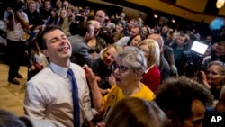 Democratic presidential candidate former South Bend, Ind., Mayor Pete Buttigieg, left, reacts as he greets members of the audience during a campaign stop at Iowa State University, Jan. 13, 2020, in Aimes, Iowa. 