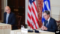 Secretary of State Antony Blinken speaks as Greece's Foreign Minister Nikos Dendias looks on during an event at the State Department in Washington, Oct. 14, 2021.