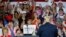 Supporters cheer for President Donald Trump, right, during a rally, Aug. 4, 2018, in Lewis Center, Ohio. 