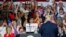 Supporters cheer for President Donald Trump, right, during a rally, Aug. 4, 2018, in Lewis Center, Ohio. 
