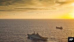 A Swedish warship escorts a merchant vessel off the coast of Somalia (file photo)