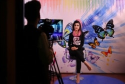 Karishma Naz, music presenter on Zan TV records a show, in Kabul, Afghanistan, Aug. 22, 2019.