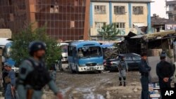 Afghan security forces inspect site of suicide car bombing in Kabul, May 19, 2015.