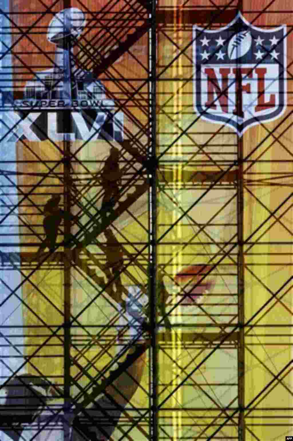 Rider climb up scaffolding for a ride down one of the four 800-foot-long zip lines in the Super Bowl Village for Super Bowl XLVI in Indianapolis, Friday, Jan. 27, 2012. The New England Patriots will face the New York Giants on Feb. 5. (AP Photo/Michael Co