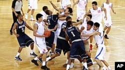 Players from American Georgetown University men's basketball team and China's Bayi men's basketball team fight during a basketball friendly game at the Beijing Olympic Basketball Arena, August 18, 2011