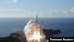 Handout photo shows an H-2A rocket carrying the Hope Probe lifts off from the launching pad at Tanegashima Space Center on the island of Tanegashima, Japan