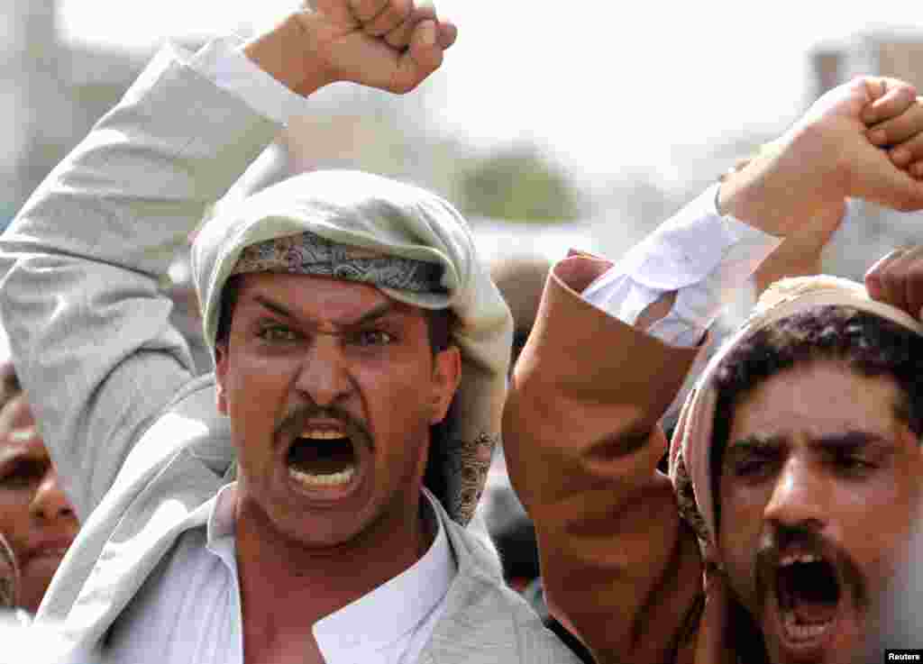 On a road leading to the U.S. embassy in Sanaa, protesters shout slogans against the anti-Islam film made in the U.S. mocking the Prophet Muhammad, September 21, 2012.