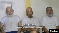 Three Israeli hostages appear in footage by Hamas at a location given as Gaza, in this still image obtained from handout video released Dec. 18, 2023. (Hamas Military Wing/Handout via REUTERS).