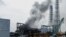 FILE - Smoke is seen coming from the Fukushima Daiichi nuclear power plant in northeastern Japan, March 21, 2011.