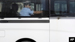 A prison van believed to be carrying some of the four detained American journalists leaves the Public Prosecution offices in Manama, Bahrain, Feb. 16, 2016.